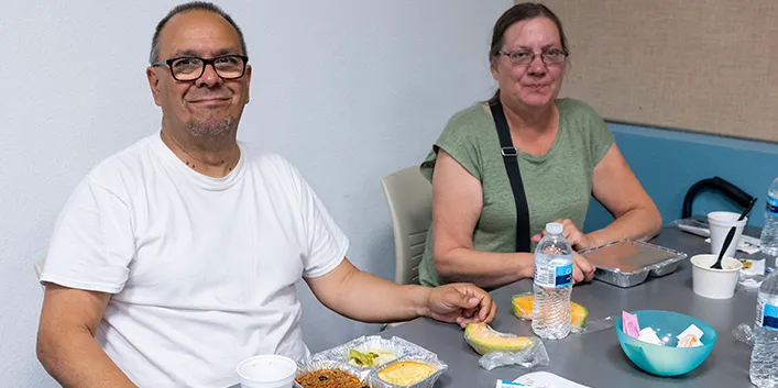 Photo of a couple having lunch at a Senior Meal site.